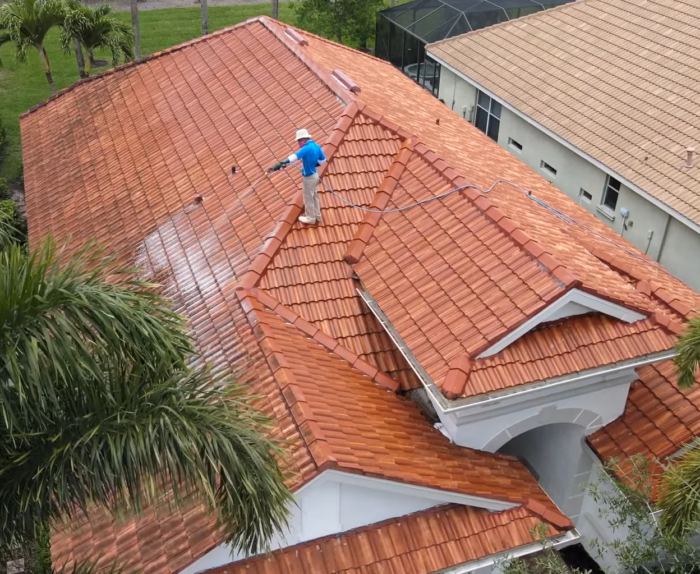 International Roofing Soft Washing a Concrete Tile Roof